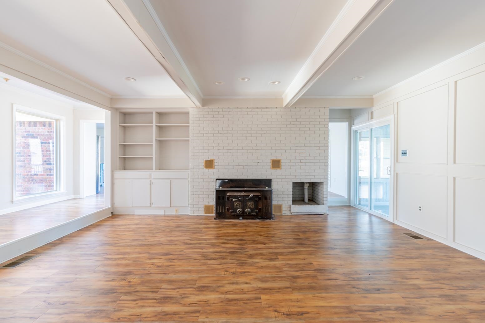 415 Key Road Collierville, TN 38017 - Photo 3 of 40 an empty room with wooden floor and fireplace