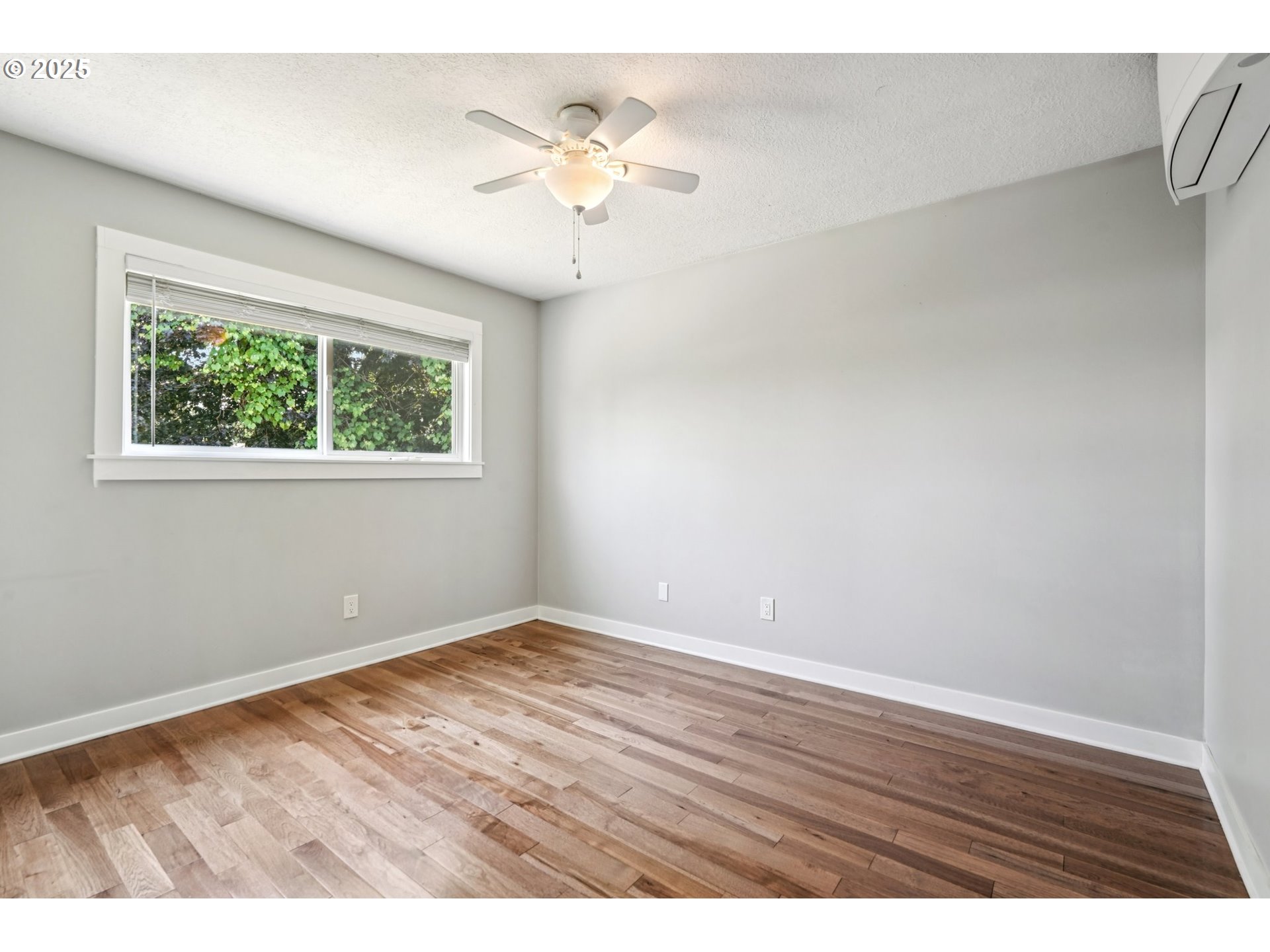 704 Southeast 207th Avenue Gresham, OR 97030 - Photo 14 of 35 an empty room with wooden floor and windows