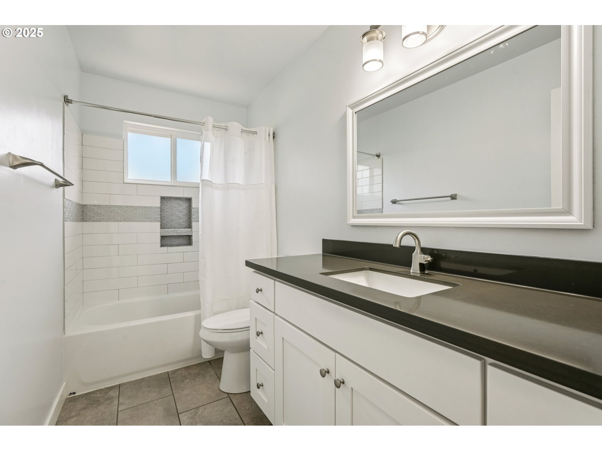 704 Southeast 207th Avenue Gresham, OR 97030 - Photo 16 of 35 a bathroom with a granite countertop sink a toilet a mirror and shower