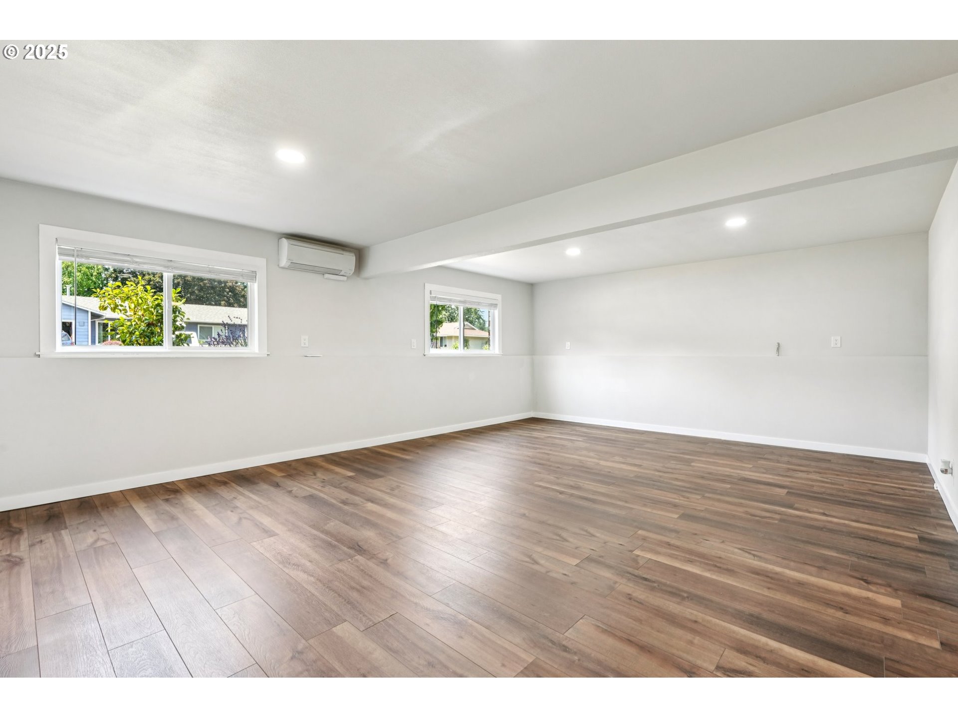 704 Southeast 207th Avenue Gresham, OR 97030 - Photo 20 of 35 an empty room with wooden floor and windows