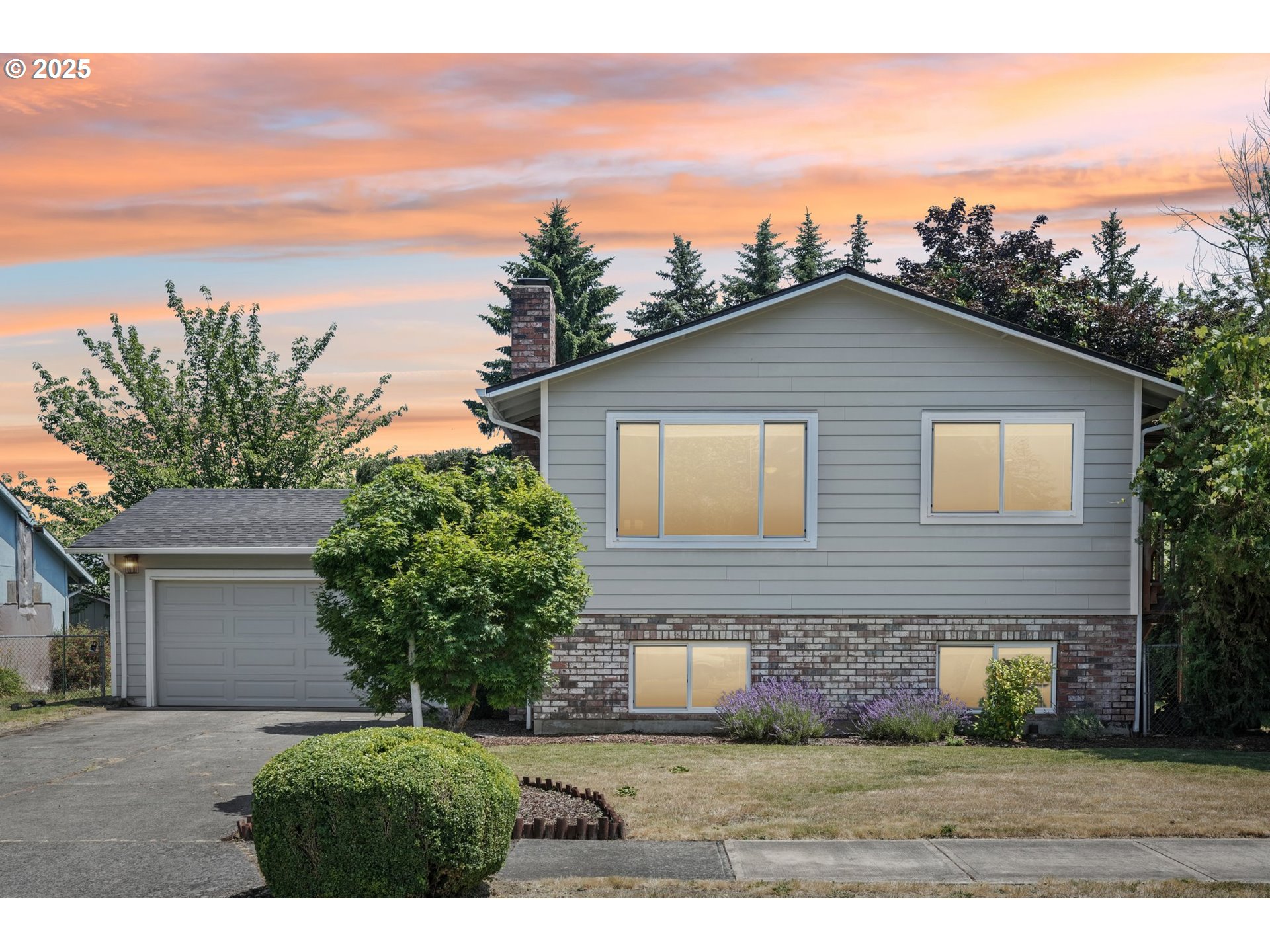 704 Southeast 207th Avenue Gresham, OR 97030 - Photo 2 of 35 a front view of a house with a yard