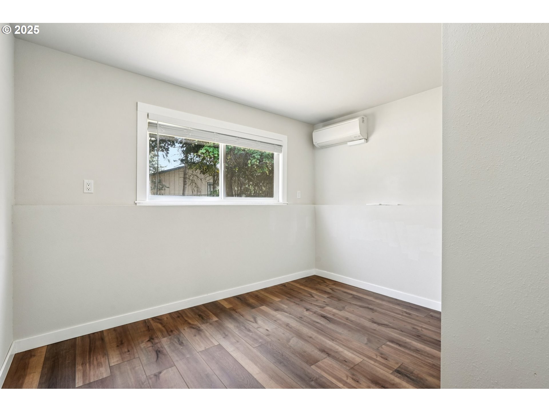 704 Southeast 207th Avenue Gresham, OR 97030 - Photo 22 of 35 a view of an empty room with wooden floor and a window