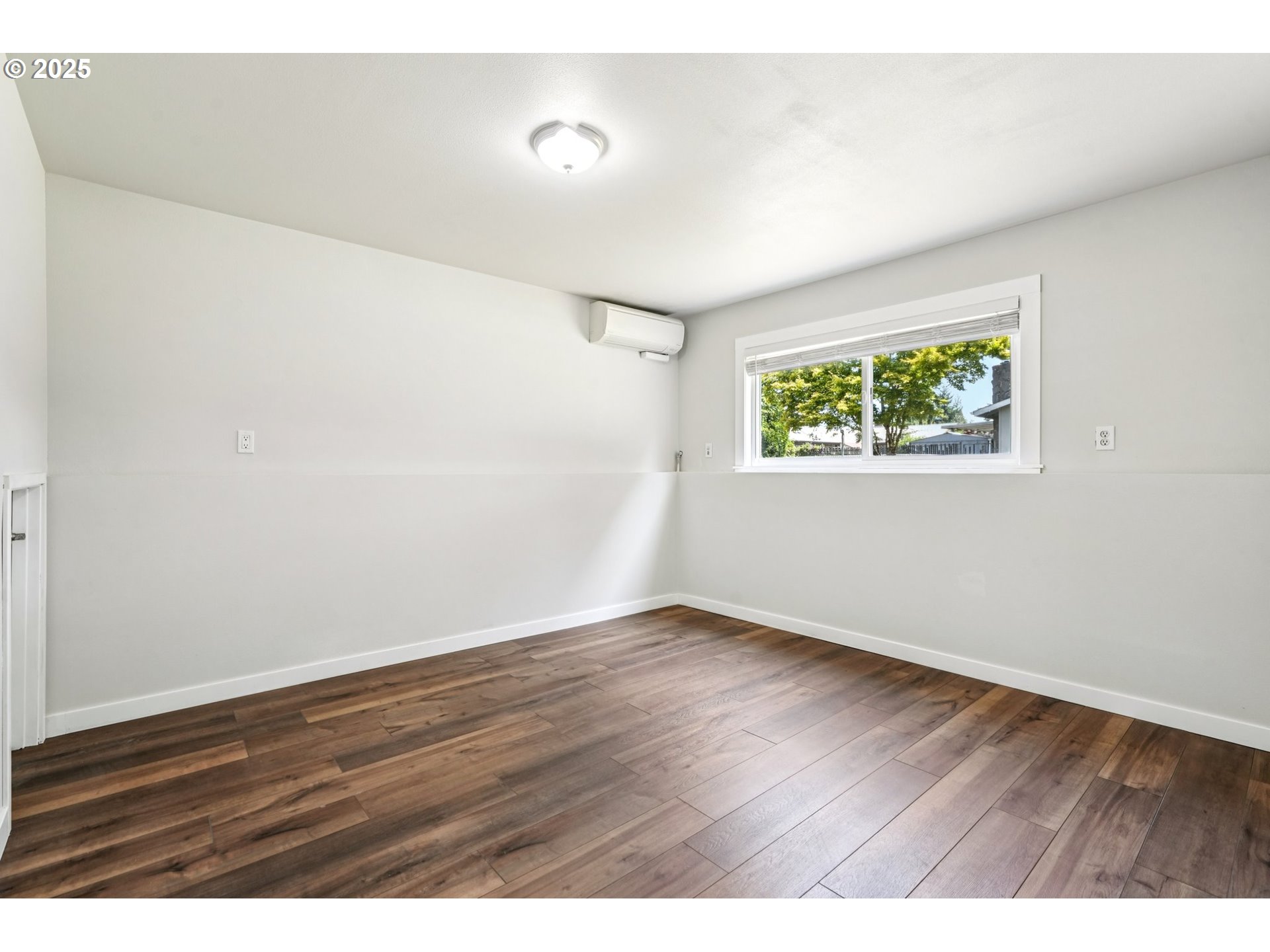 704 Southeast 207th Avenue Gresham, OR 97030 - Photo 23 of 35 an empty room with wooden floor and windows