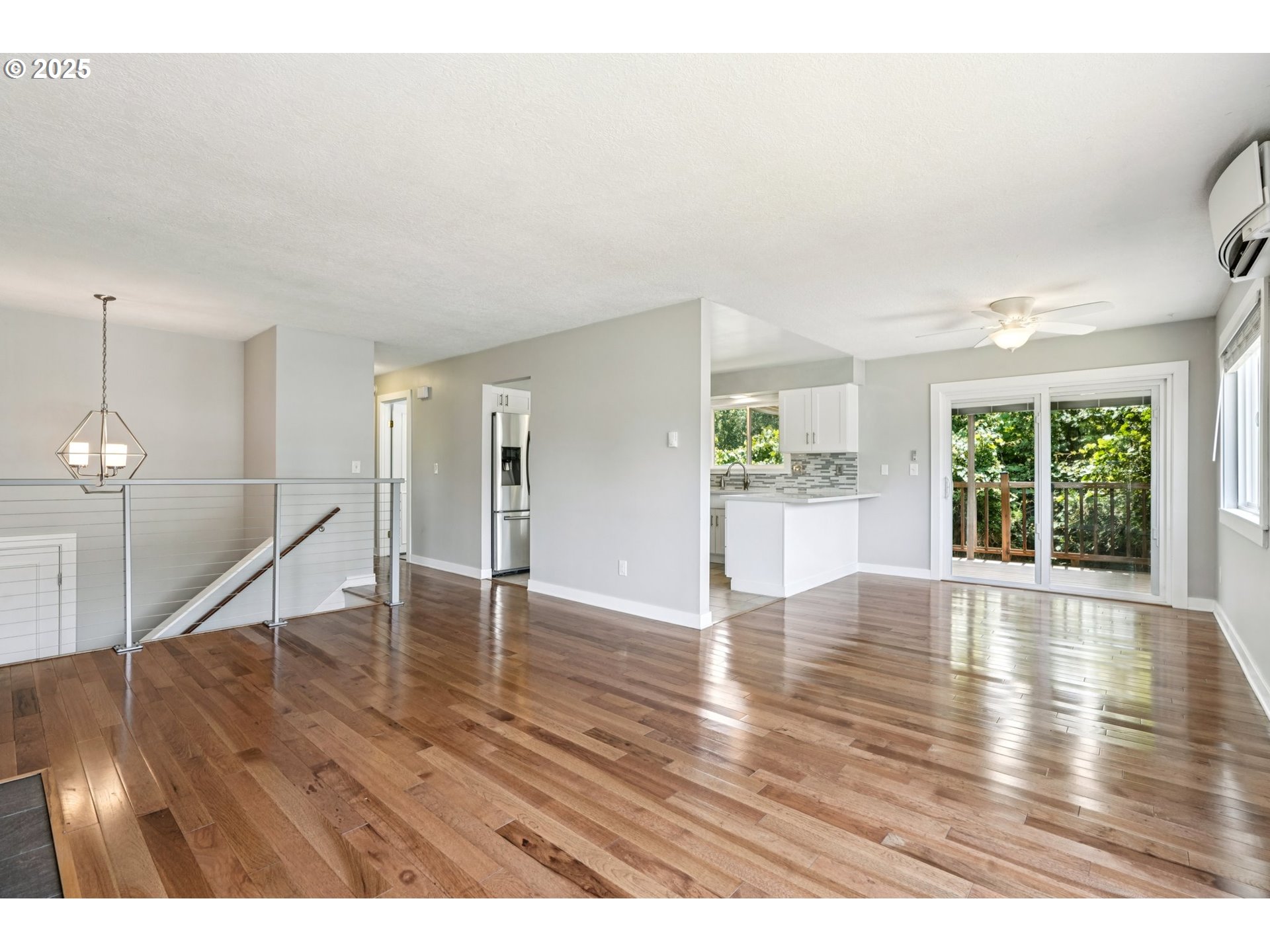 704 Southeast 207th Avenue Gresham, OR 97030 - Photo 5 of 35 a view of an empty room with wooden floor and a window