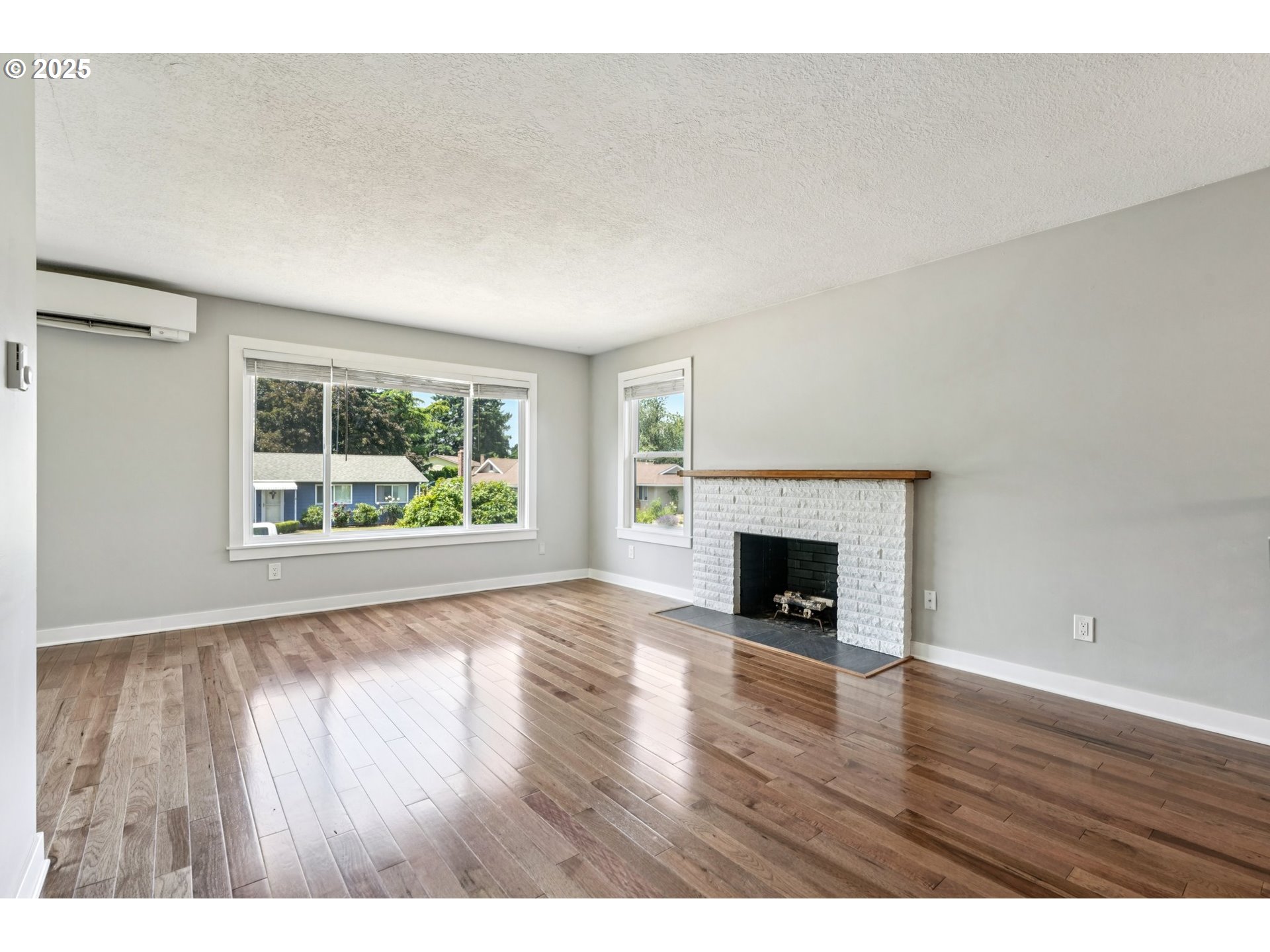 704 Southeast 207th Avenue Gresham, OR 97030 - Photo 6 of 35 a view of an empty room with wooden floor and a window