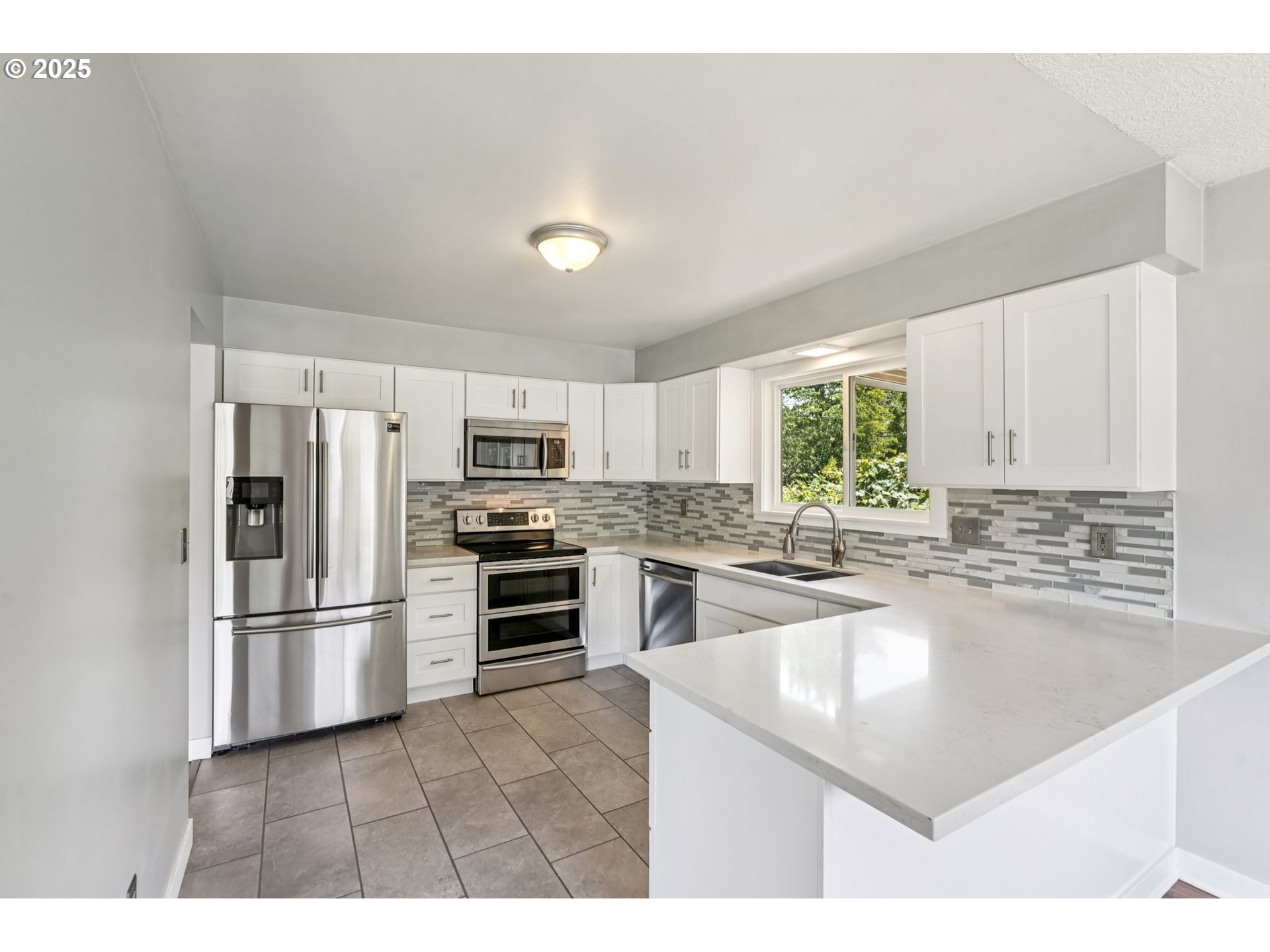 704 Southeast 207th Avenue Gresham, OR 97030 - Photo 9 of 35 a kitchen with stainless steel appliances granite countertop a refrigerator sink and stove