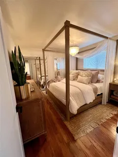 a bedroom with double bed and a window