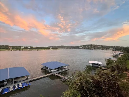a view of a lake with houses in the back