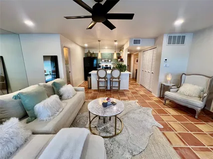 a living room with furniture and a chandelier