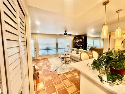 a living room with furniture and a floor to ceiling window