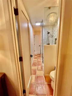 a bathroom with a sink and mirror with toilet