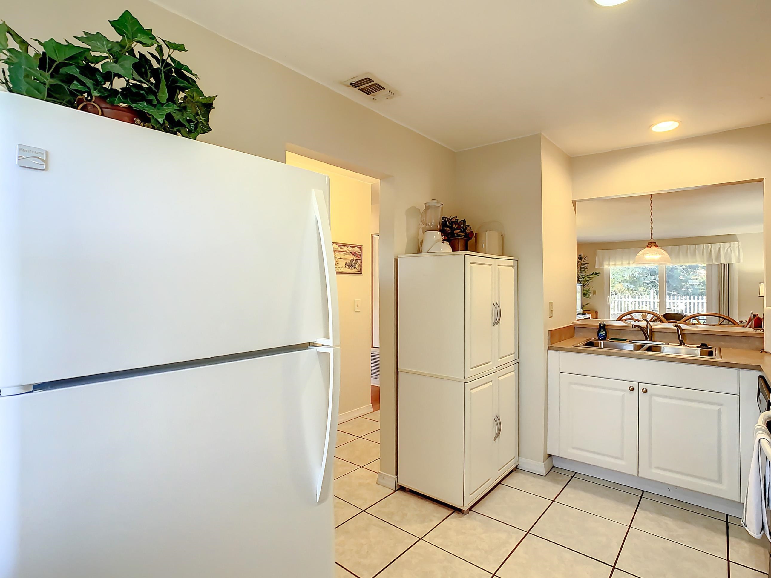 4 Ocean Trace Road, Unit 5 St. Augustine, FL 32080 - Photo 14 of 35 a white refrigerator freezer sitting in a kitchen