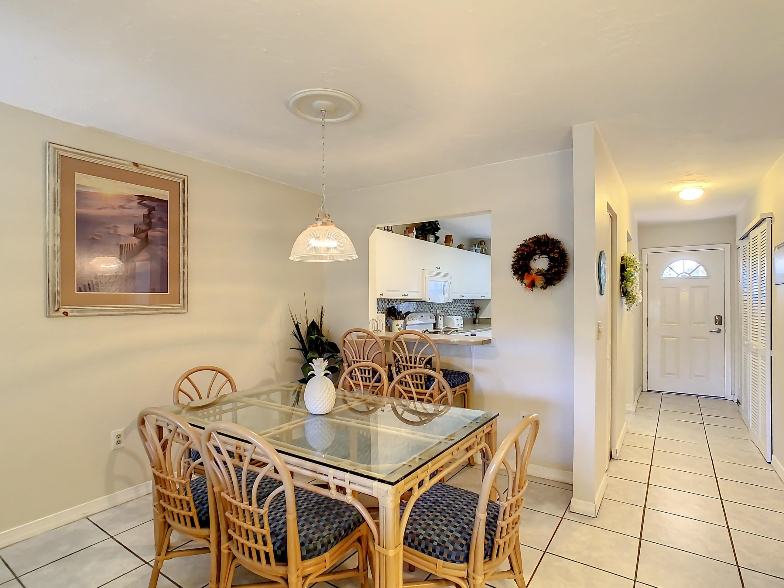 4 Ocean Trace Road, Unit 5 St. Augustine, FL 32080 - Photo 17 of 35 a view of a dining room with furniture and chandelier