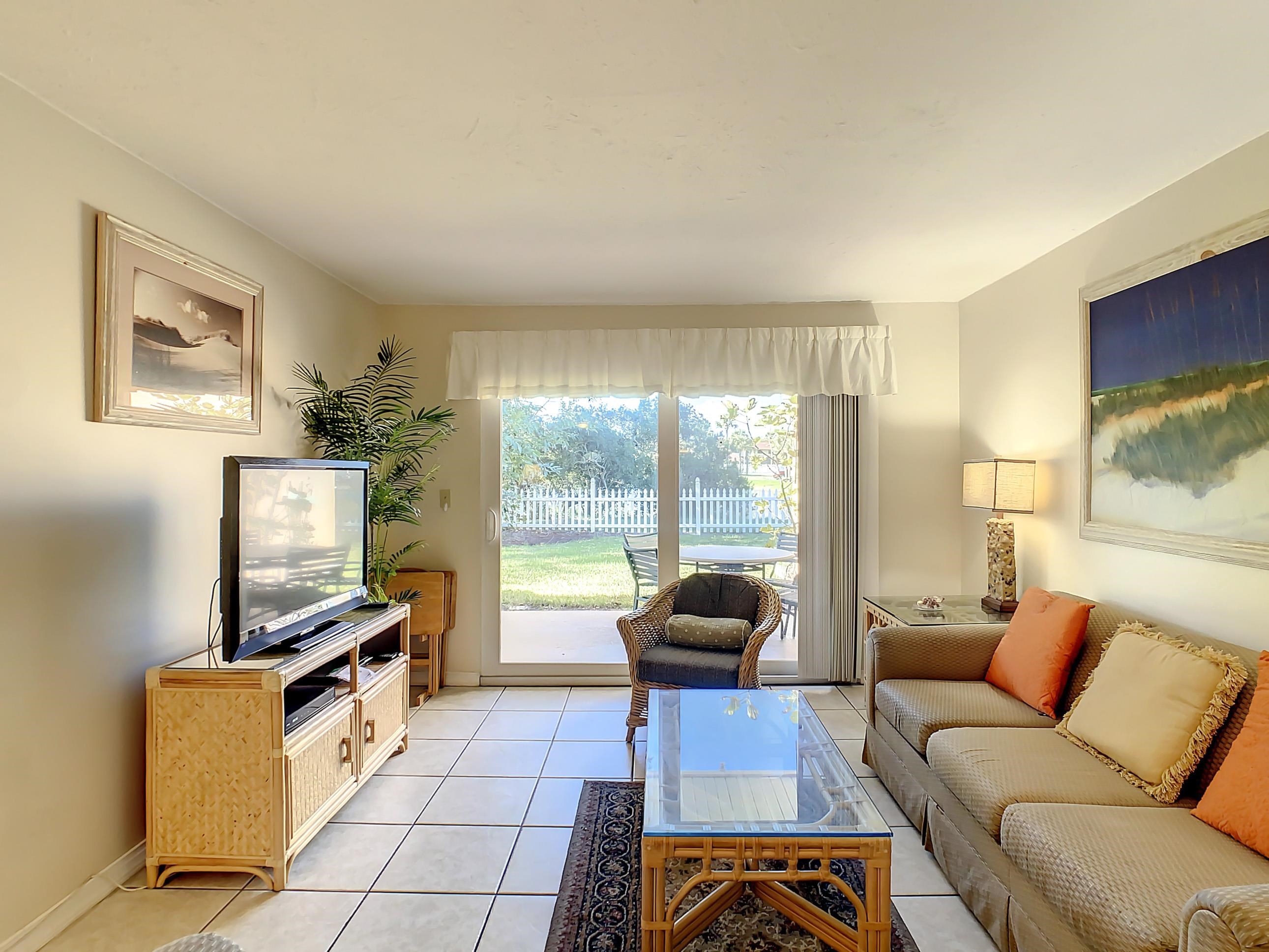 4 Ocean Trace Road, Unit 5 St. Augustine, FL 32080 - Photo 21 of 35 a living room with furniture and a flat screen tv