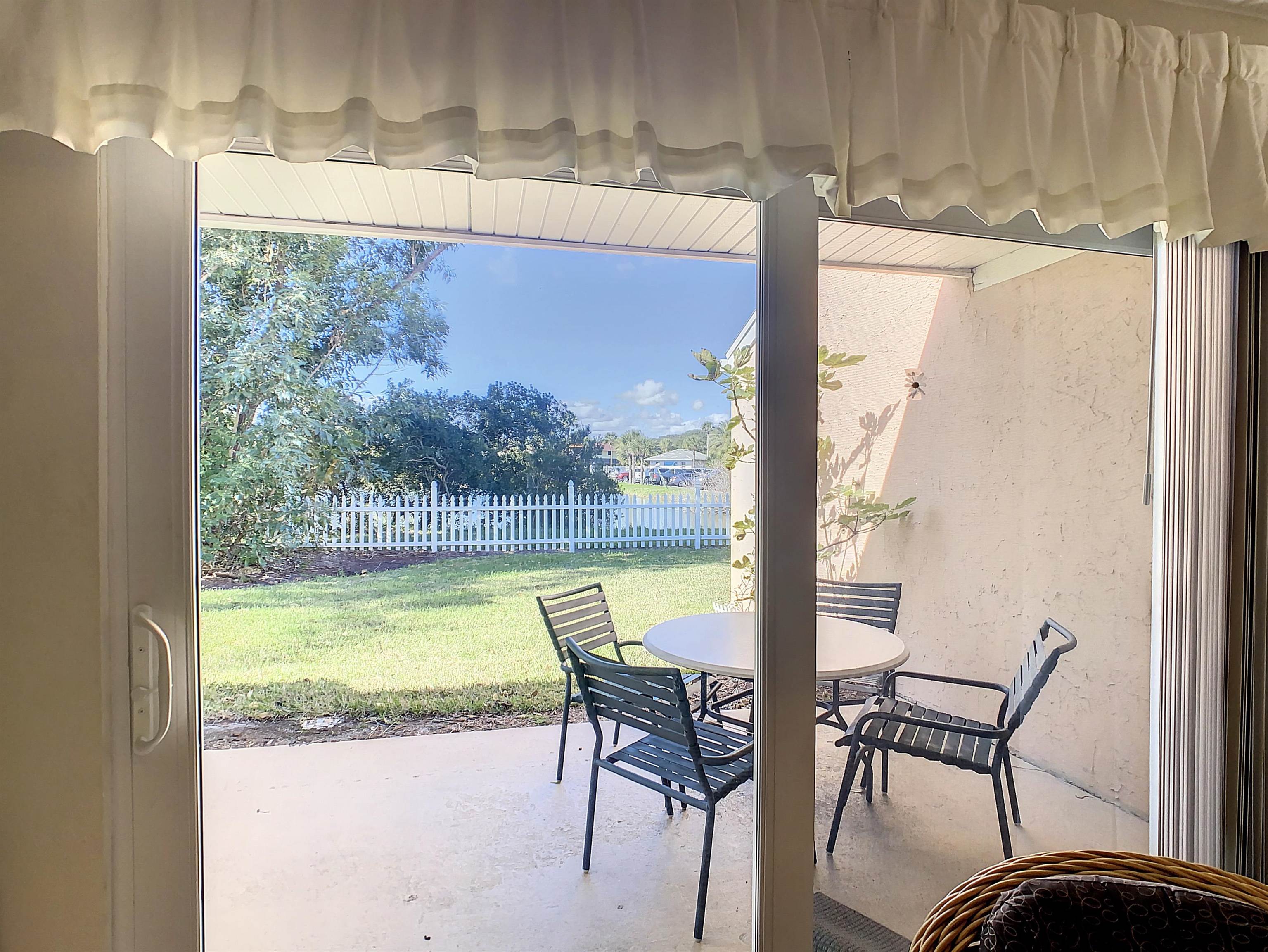 4 Ocean Trace Road, Unit 5 St. Augustine, FL 32080 - Photo 23 of 35 a view of a swimming pool with a table and chairs