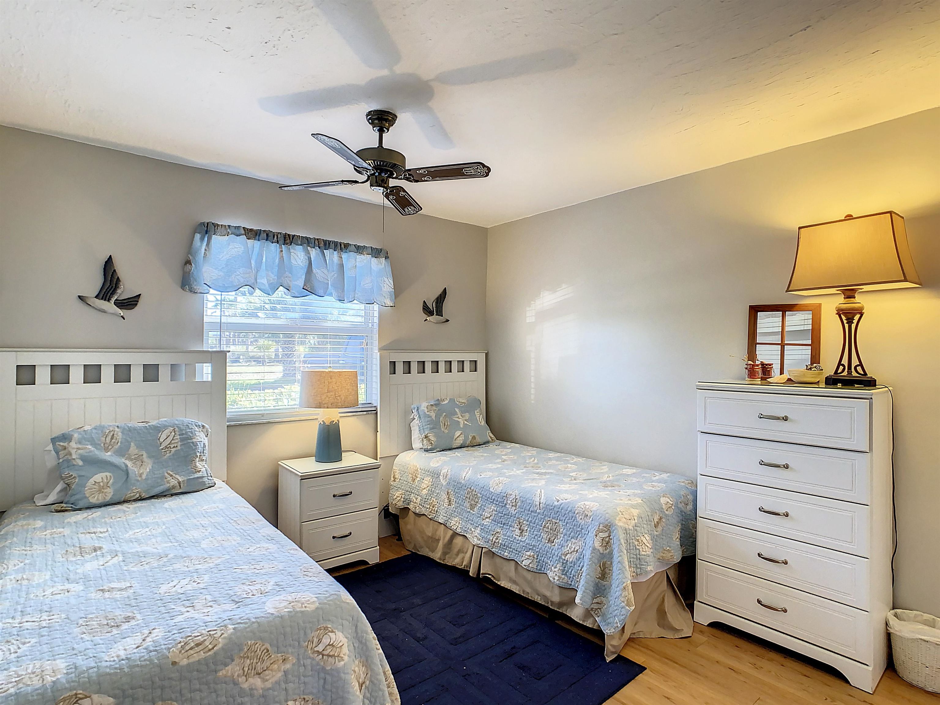 4 Ocean Trace Road, Unit 5 St. Augustine, FL 32080 - Photo 24 of 35 a bedroom with a bed and a night stand