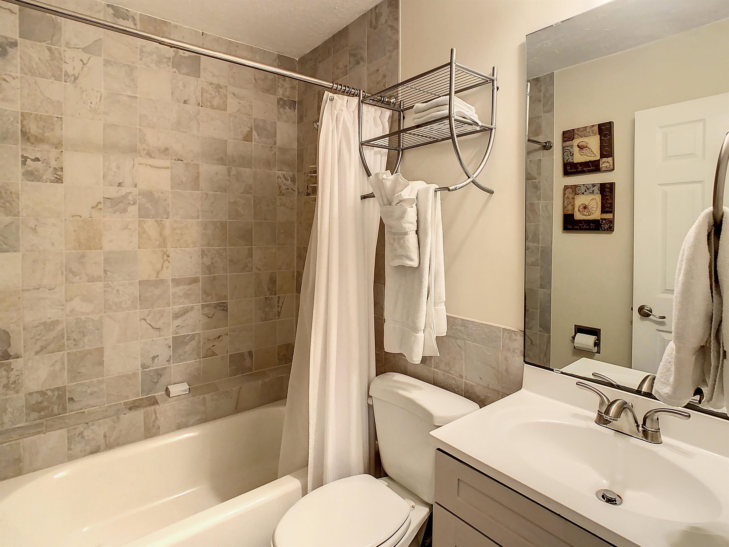 4 Ocean Trace Road, Unit 5 St. Augustine, FL 32080 - Photo 26 of 35 a bathroom with a sink toilet and shower