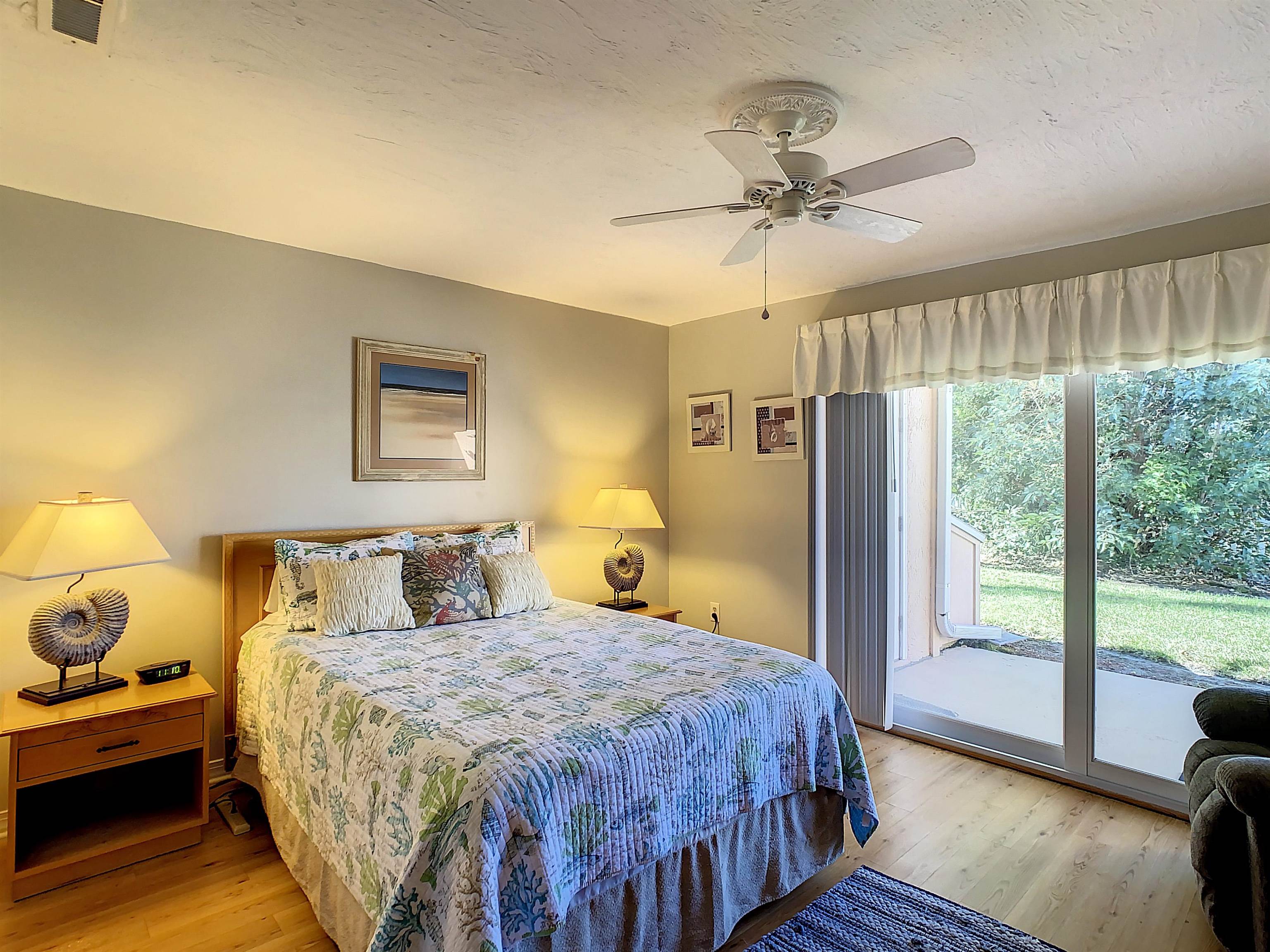 4 Ocean Trace Road, Unit 5 St. Augustine, FL 32080 - Photo 29 of 35 a bedroom with a bed and wooden floor