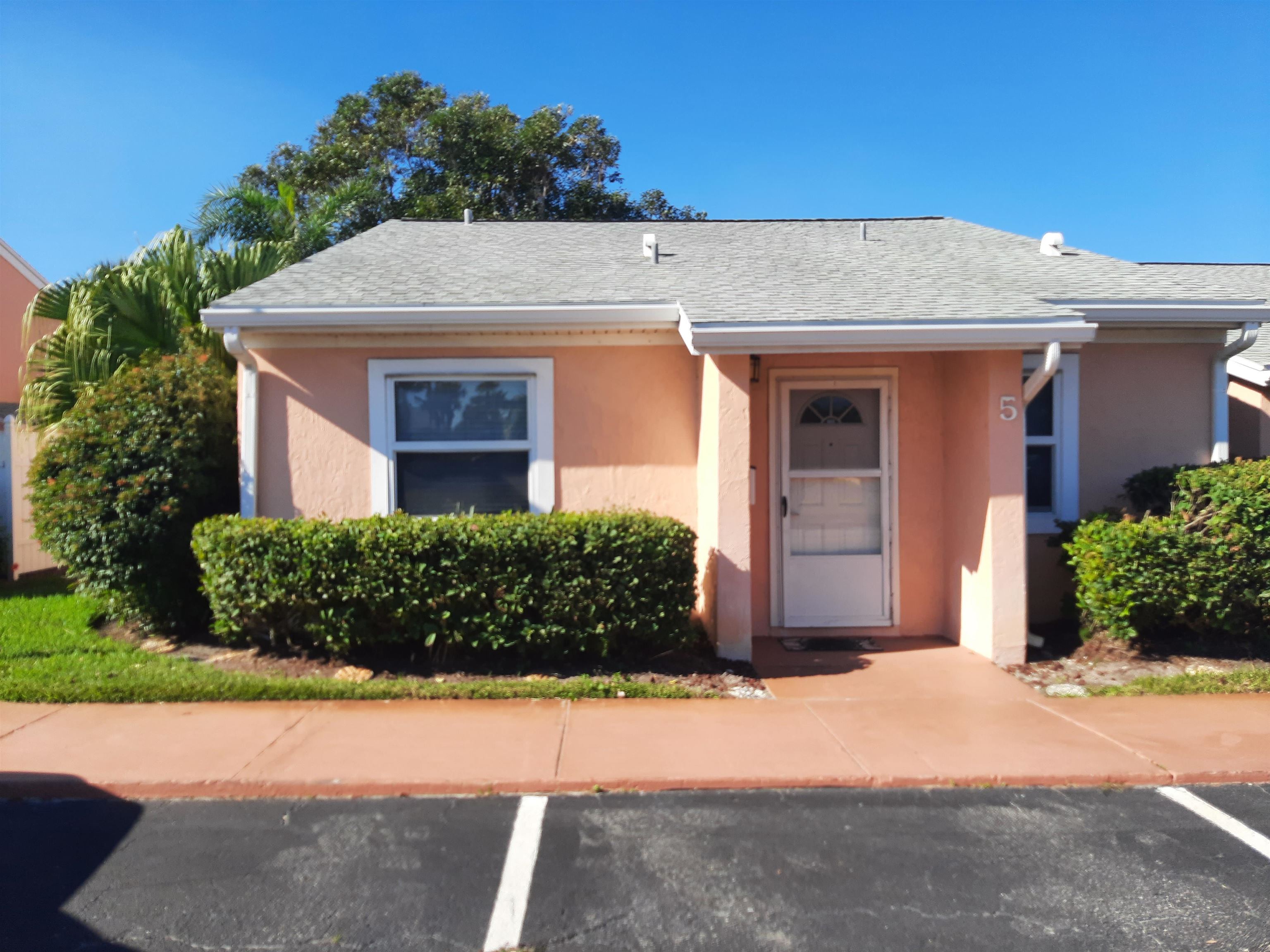 4 Ocean Trace Road, Unit 5 St. Augustine, FL 32080 - Photo 3 of 35 a front view of a house with a garden