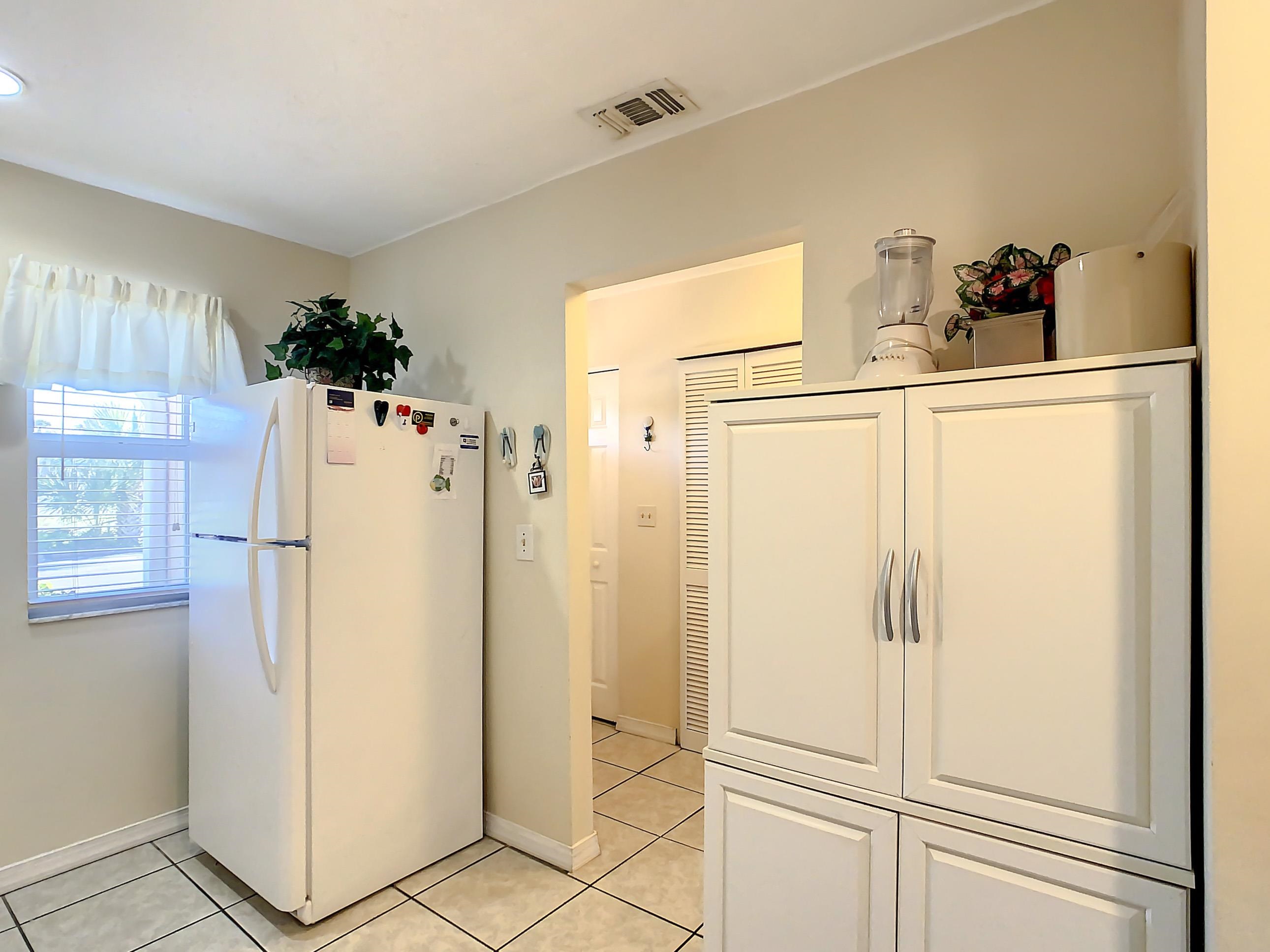 4 Ocean Trace Road, Unit 5 St. Augustine, FL 32080 - Photo 9 of 35 a white refrigerator freezer sitting in a kitchen