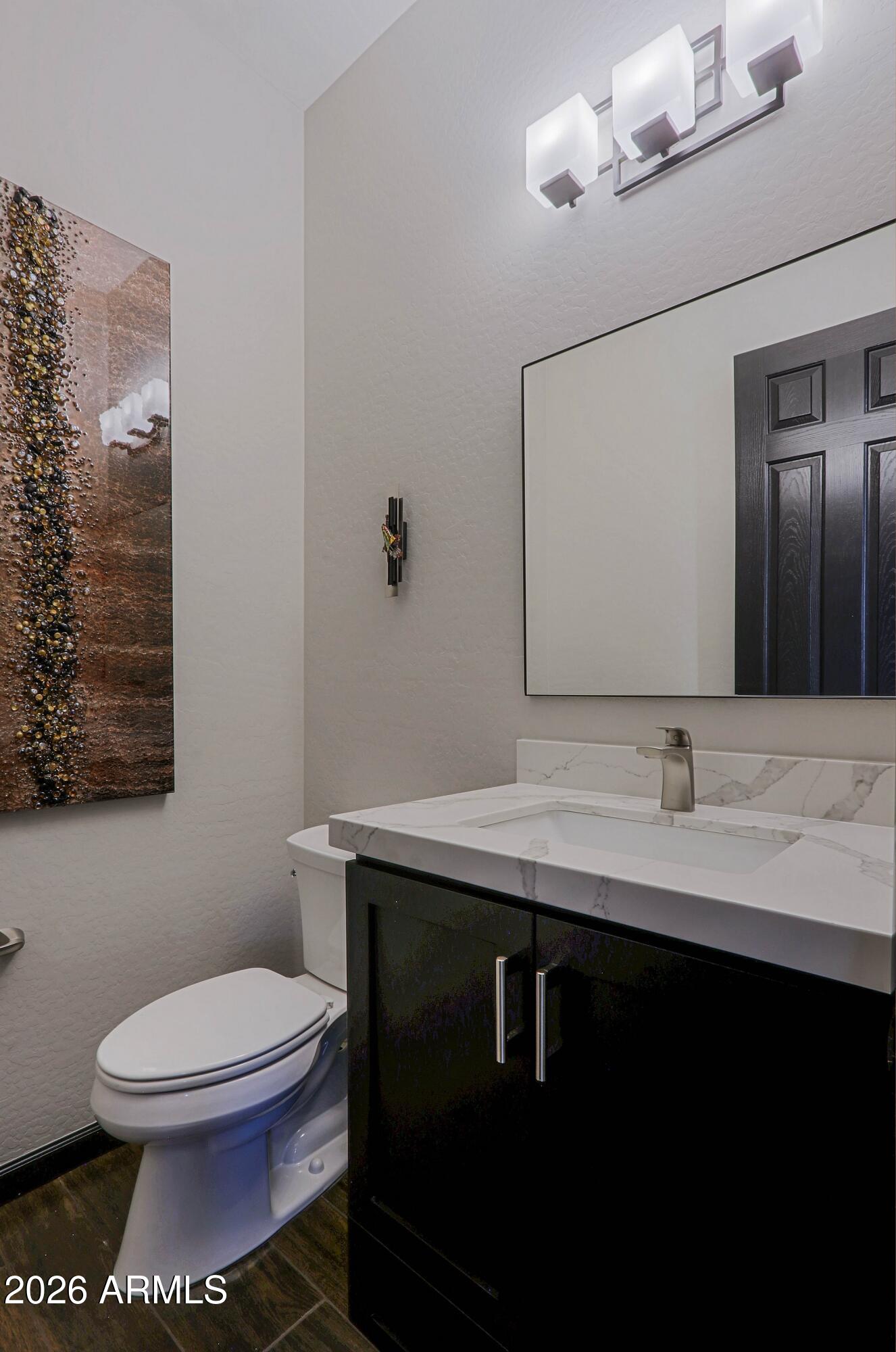 17623 East Fort Verde Road Rio Verde, AZ 85263 - Photo 45 of 57 a bathroom with a granite countertop toilet sink and mirror