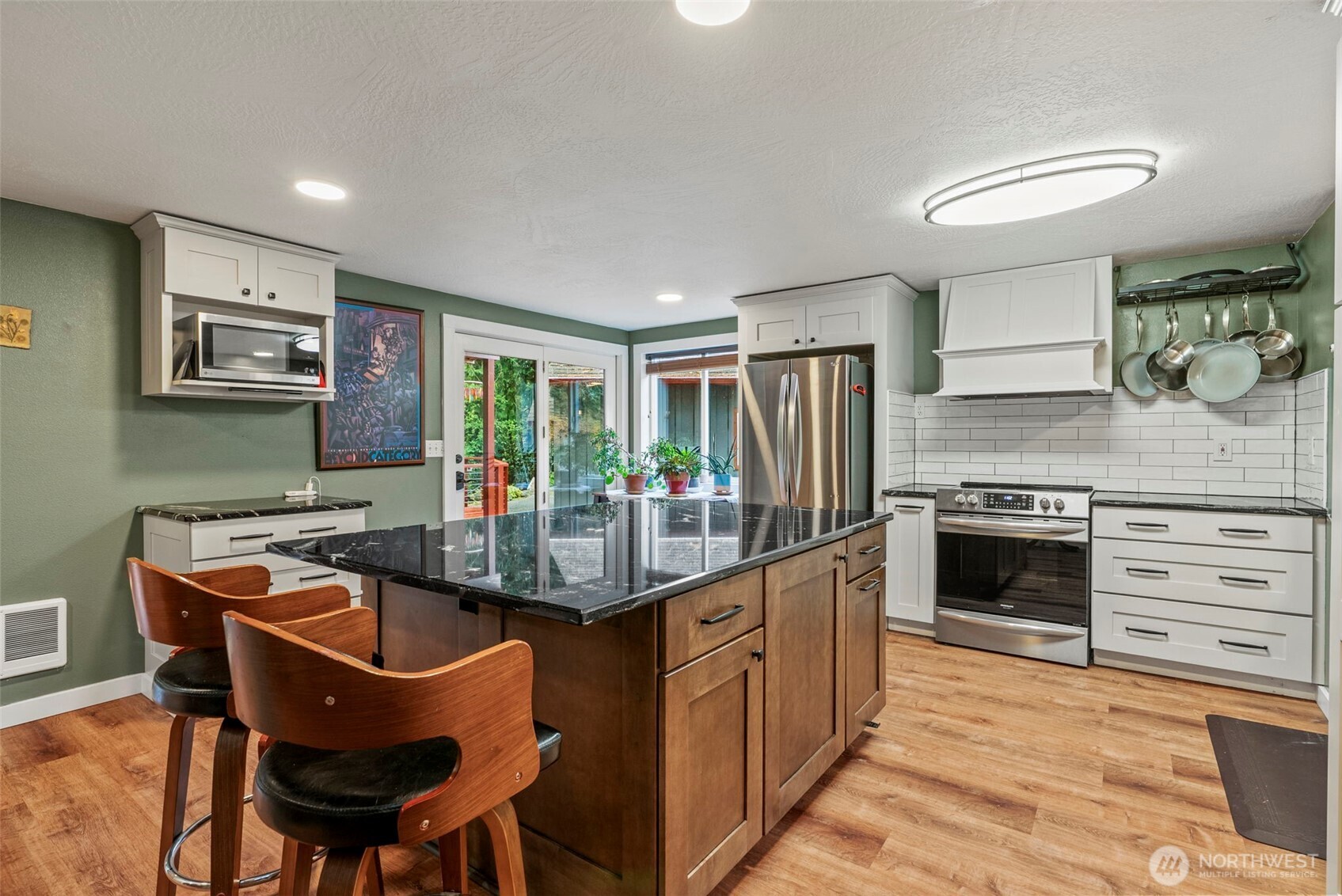 1703 Tower Road Castle Rock, WA 98611 - Photo 6 of 38 a kitchen with kitchen island stainless steel appliances a stove a sink and a refrigerator