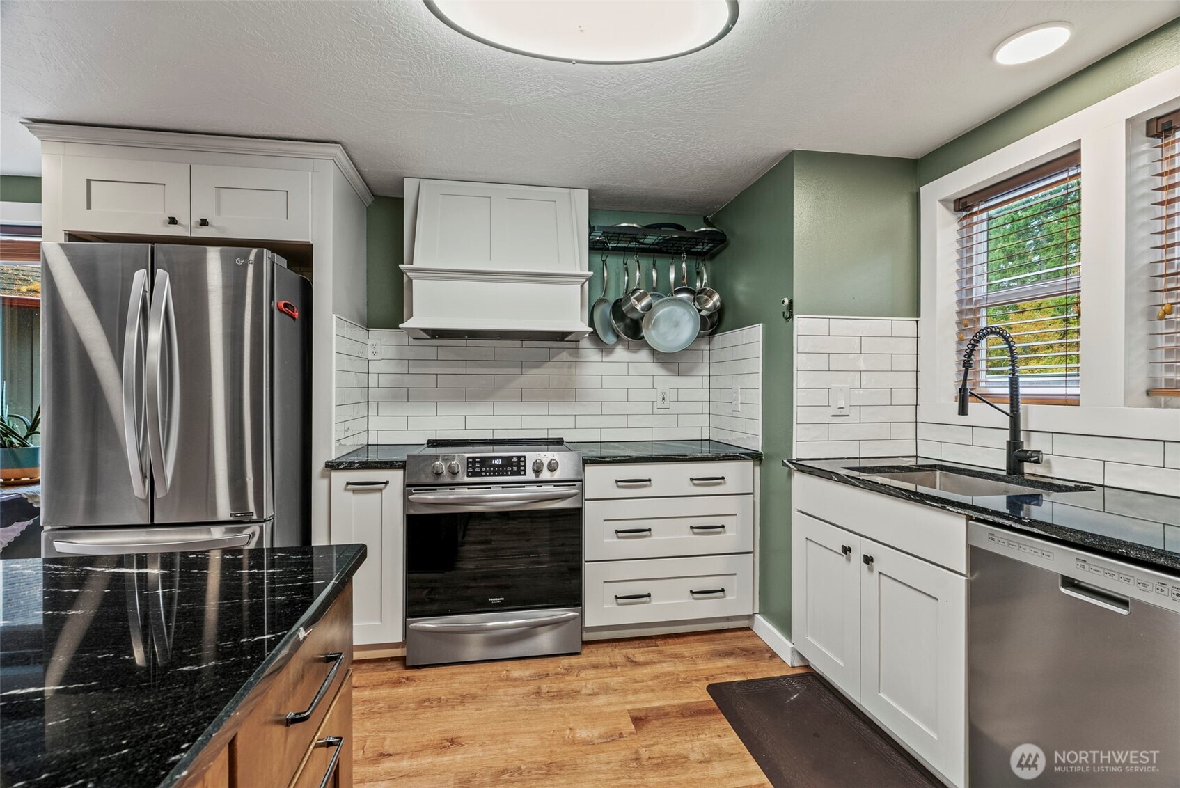 1703 Tower Road Castle Rock, WA 98611 - Photo 7 of 38 a kitchen with a sink stove and refrigerator