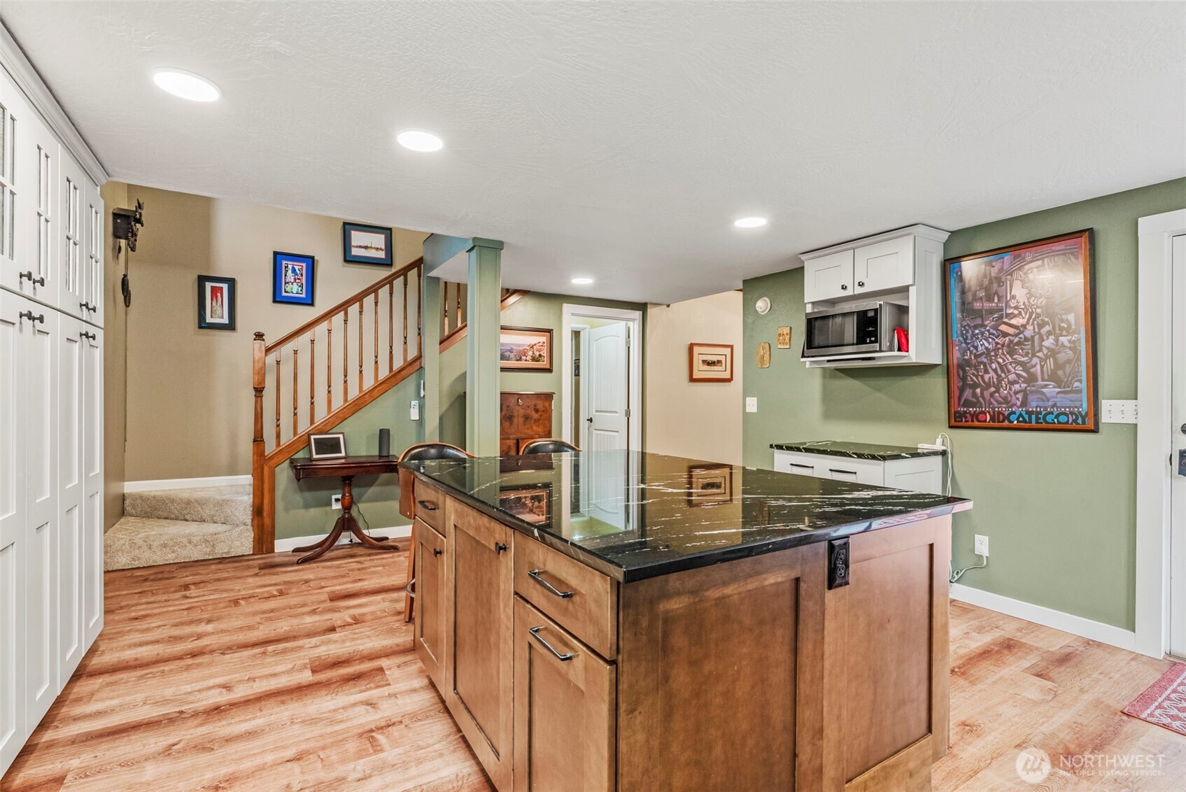 1703 Tower Road Castle Rock, WA 98611 - Photo 8 of 38 a view of kitchen island with stainless steel appliances granite countertop couches a stove top oven and a dining table with wooden floor