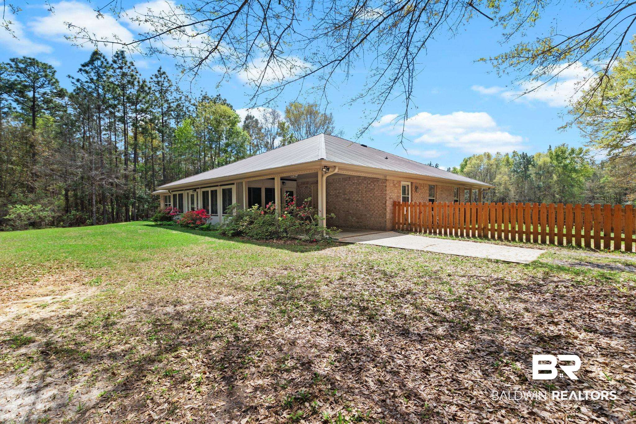 24250 Hack Road Bay Minette, AL 36507 - Photo 45 of 88 Rear view of house with a metal roof and brick siding