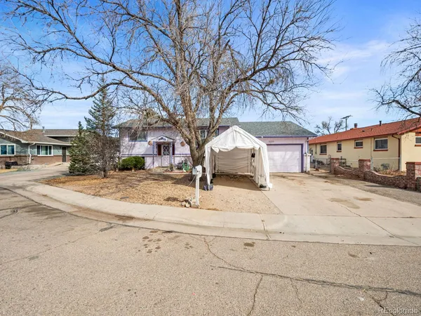 a view of white house with a snow on the road