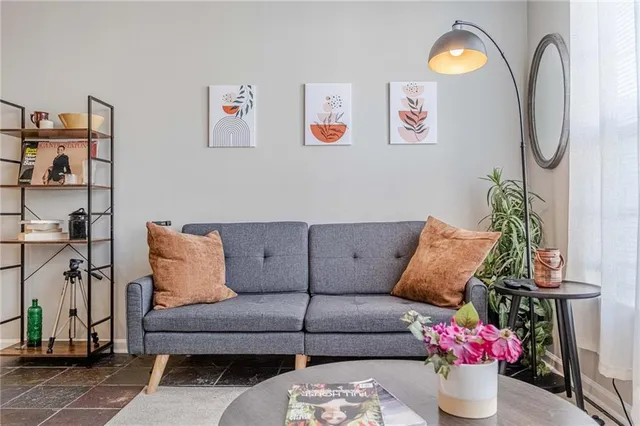 a living room with furniture and flowers
