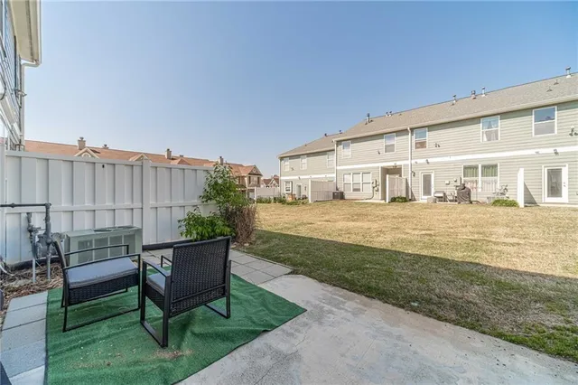 a view of house with backyard outdoor seating and barbeque oven