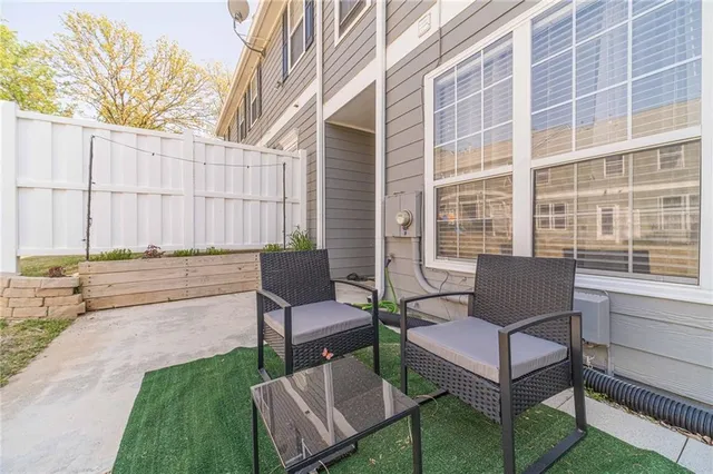 a view of a patio with couple of chairs and a couch