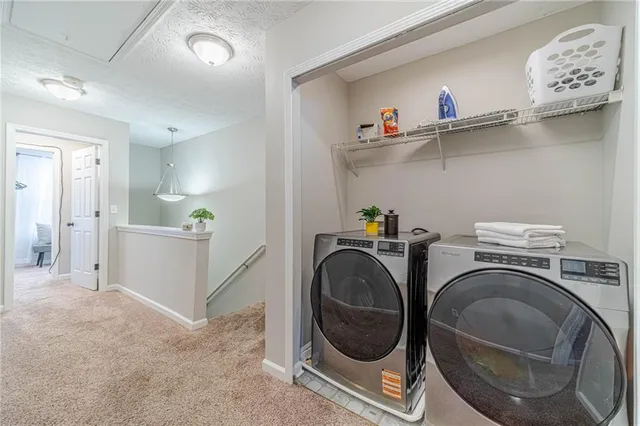 a view of storage and utility room with washer and dryer