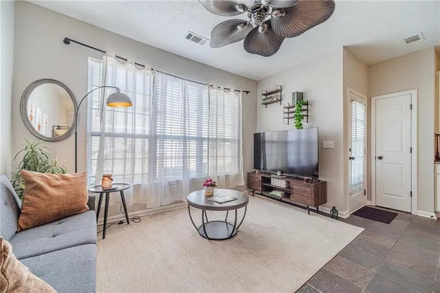 a living room with furniture a window and a chandelier