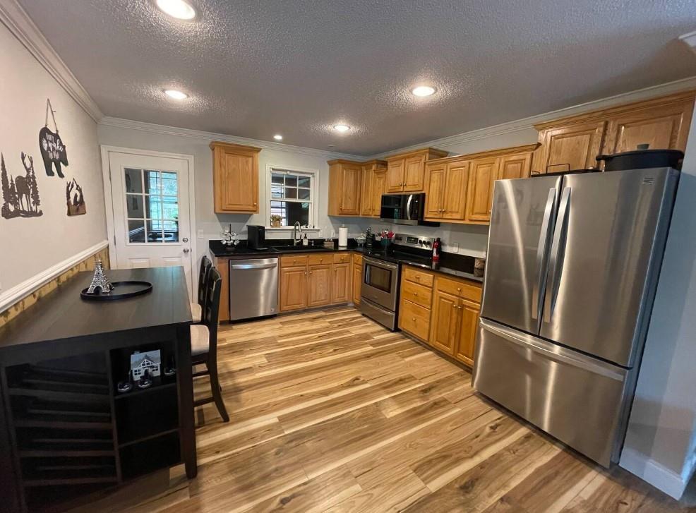40D Kuvasz Weg, Unit B Helen, GA 30545 - Photo 3 of 12 a kitchen with granite countertop stainless steel appliances and wooden cabinets