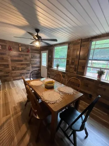 a view of a dining room with furniture window and wooden floor