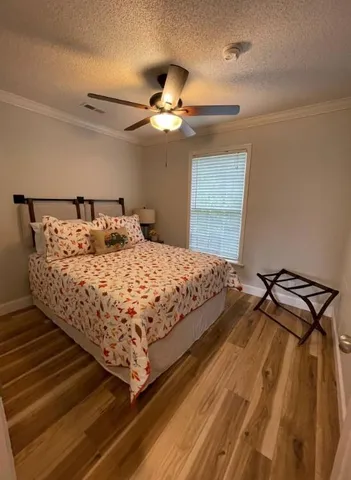 a bedroom with a bed and ceiling fan