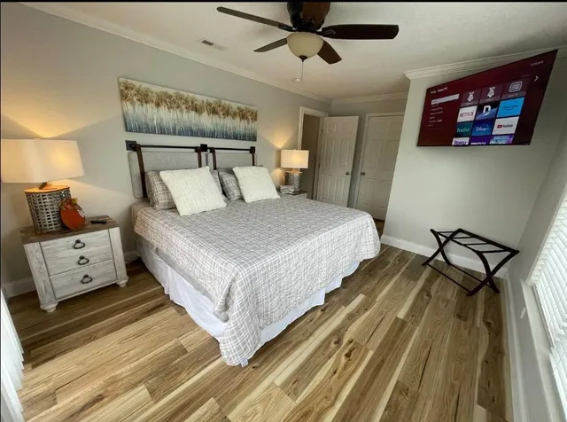 a bedroom with a bed and a chandelier