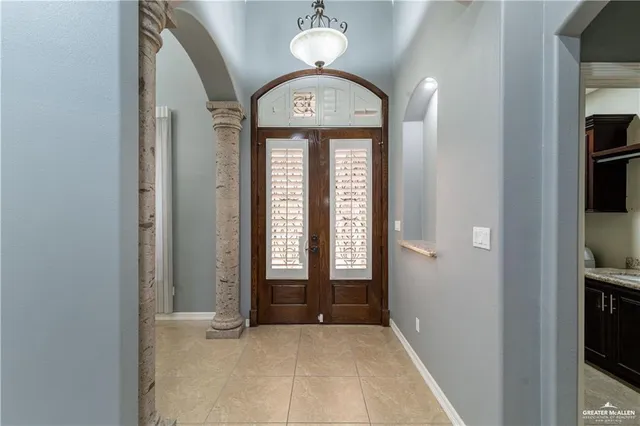 a view of a hallway with wooden floor and a front door
