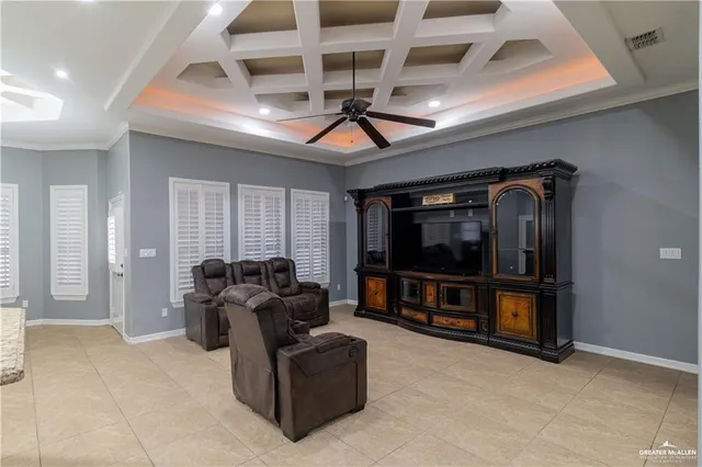 a living room with furniture a ceiling fan and a window
