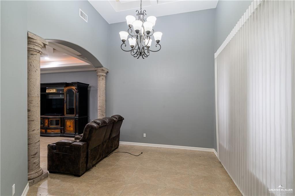 3222 South 5th Lane McAllen, TX 78503 - Photo 5 of 14 a living room with furniture and a chandelier