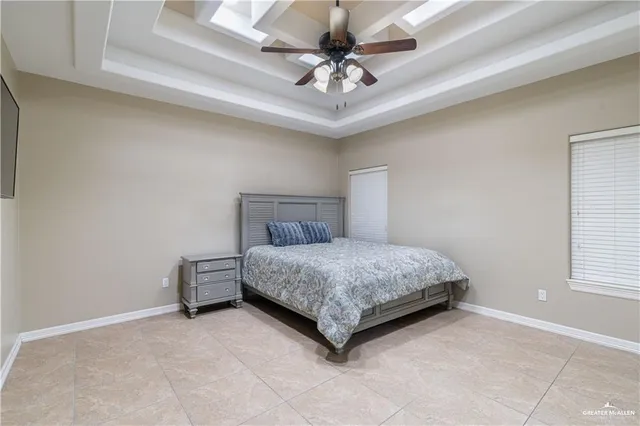 a bedroom with a bed and a ceiling fan