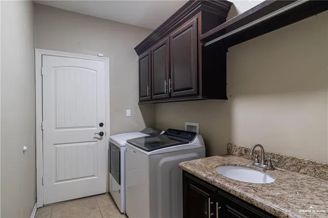 a utility room with sink dryer and washer