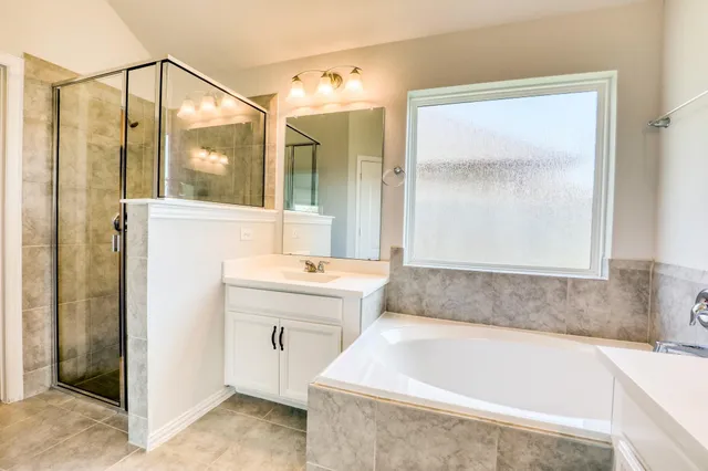 a bathroom with a bathtub and a sink