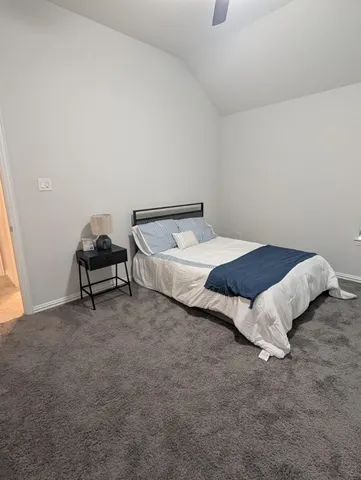 a bedroom with a bed and a chair