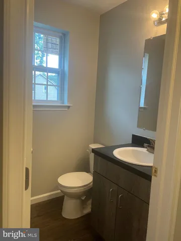 a bathroom with a toilet a sink and mirror