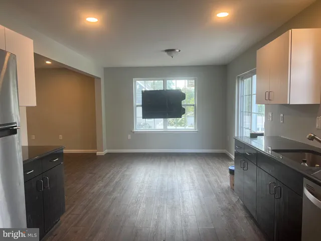 an empty room with wooden floor and a window