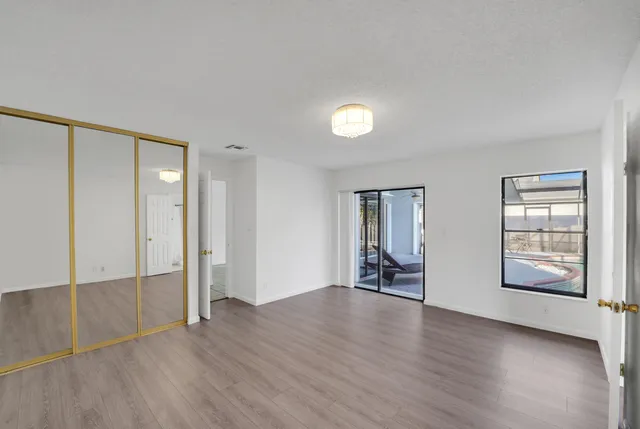 a bedroom with bed and a book shelf