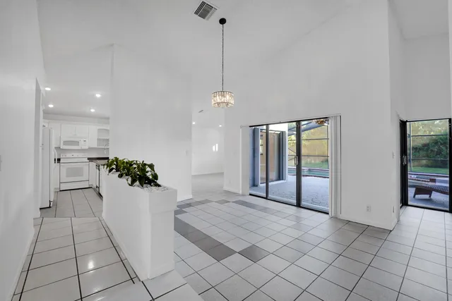 a kitchen with a sink a stove and white cabinets